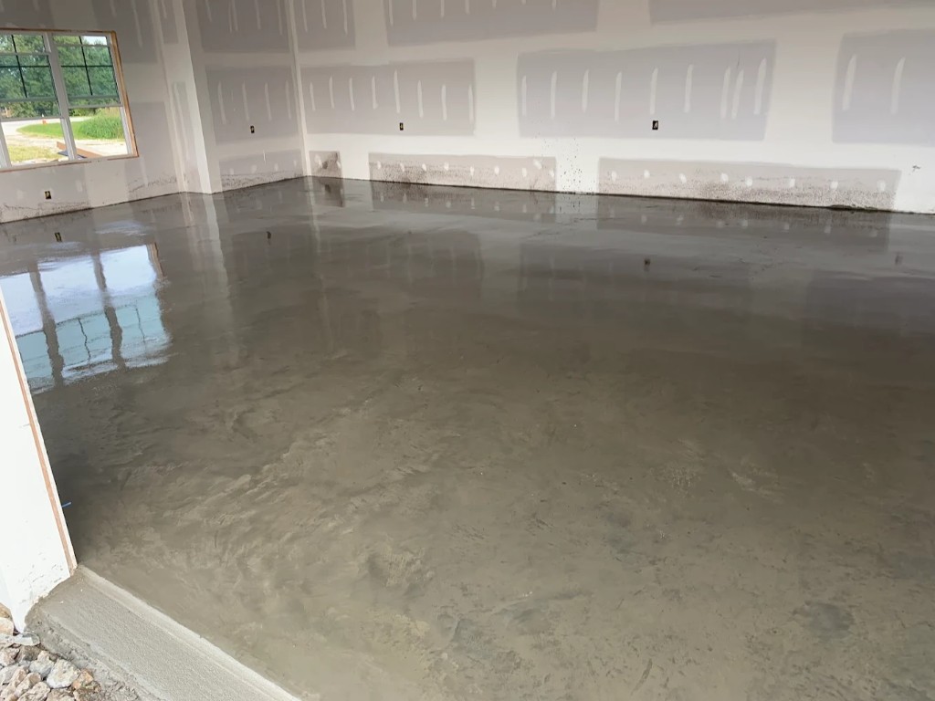 Wet interior concrete slab inside a building under construction