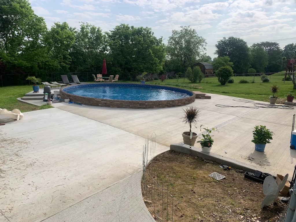 After: concrete patio, steps, and seating poured around the same pool