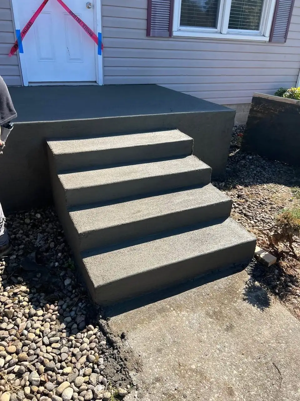 Sharp broom finished front porch landing and four concrete steps